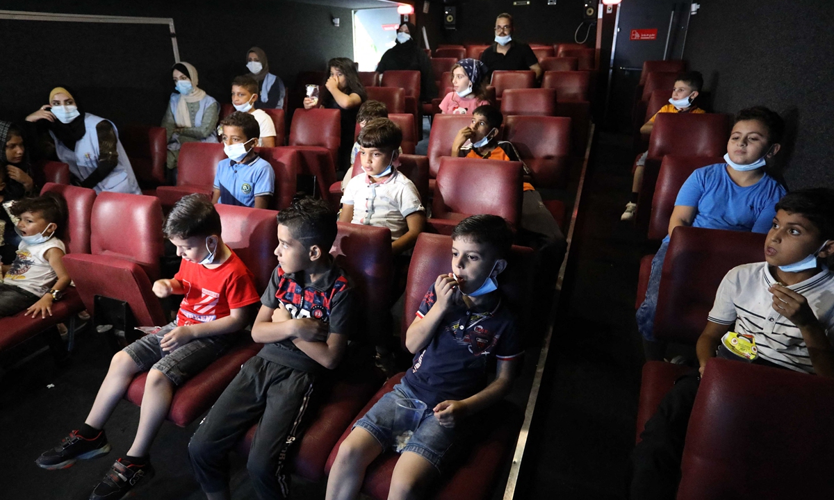 Palestinian children watch a movie in a mobile movie theater in Gaza City, Gaza on August 19. Photo: AFP