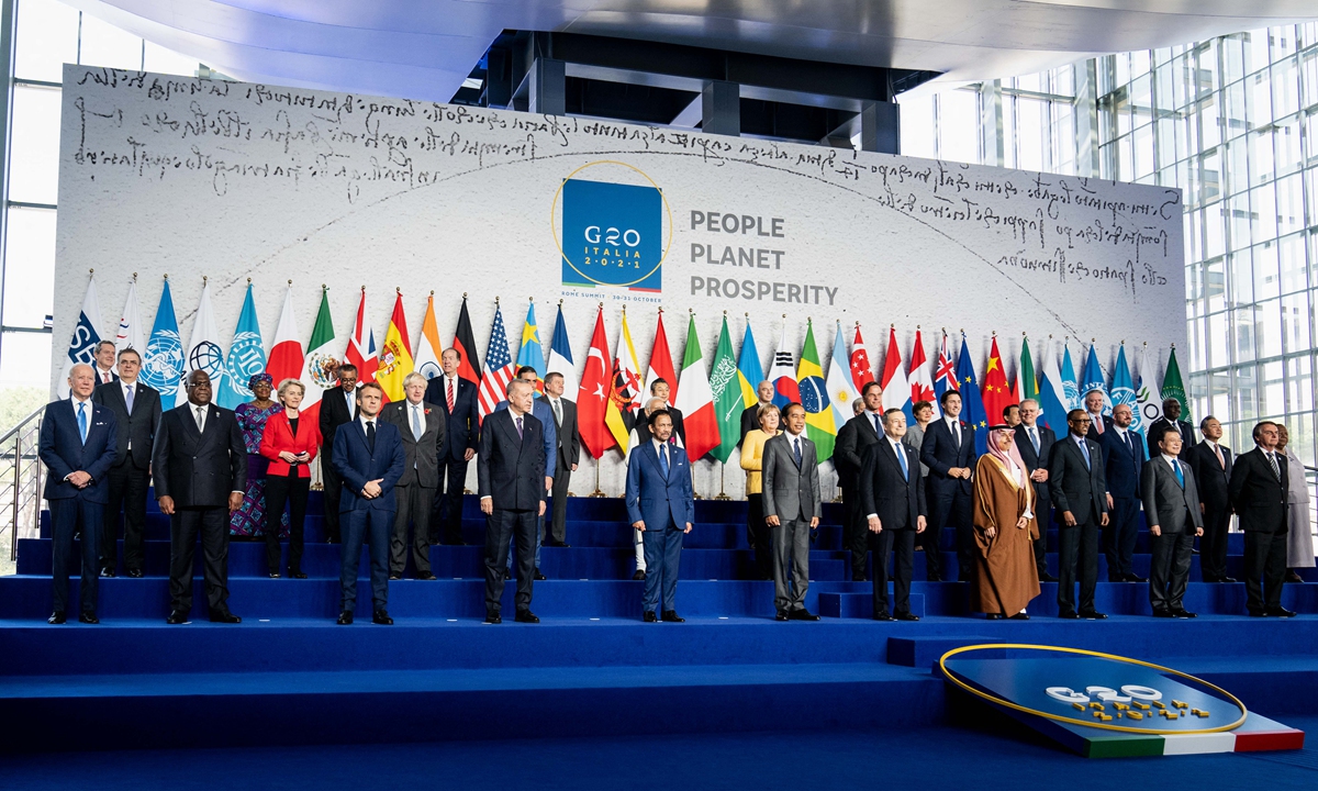 US President Joe Biden stands at the far end of a group photo at the G20 Leaders' Summit on October 30, 2021 in Rome, Italy. Photo: AFP
