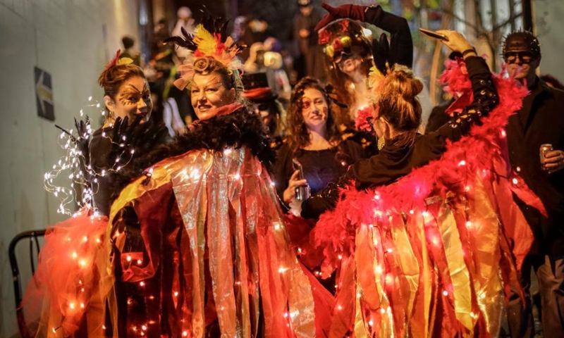 People in costumes march along the street during the Parade of Lost Souls to celebrate the Halloween in Vancouver, British Columbia, Canada, Oct. 30, 2021. (Photo:Xinhua)