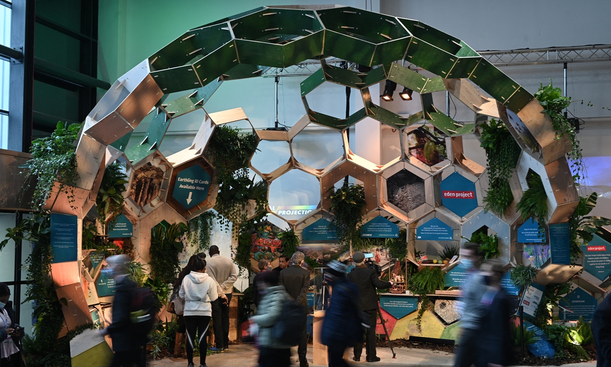 People walk past an Eden Project display inside the COP26 venue in Glasgow, the UK on Monday, on the first day of the COP26 UN Climate Change Conference being held in the city. Photo: AFP