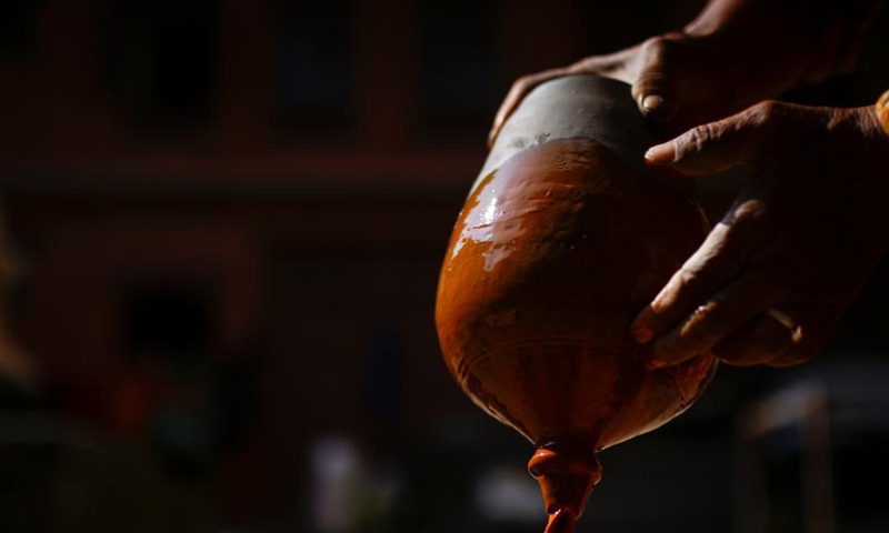 A Nepalese woman prepares a clay pot for Tihar, a Hindu festival, at Pottery Square in Bhaktapur, Nepal on Oct. 31, 2021.Photo:Xinhua