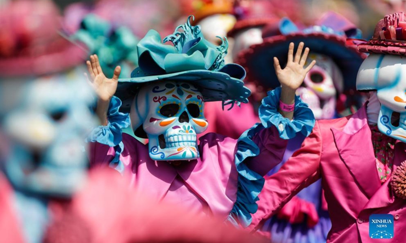 People in ghostly masks and costumes take part in the Day of the Dead Parade in downtown Mexico City, capital of Mexico, on Oct. 31, 2021.Photo:Xinhua