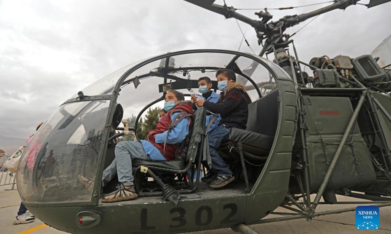 Children are seen in a helicopter cockpit during an open day at Rayak Air Base in Bekaa, Lebanon, on Oct. 31, 2021.Photo:Xinhua