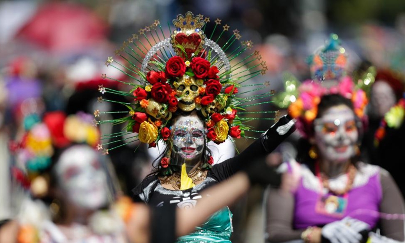 People in ghostly masks and costumes take part in the Day of the Dead Parade in downtown Mexico City, capital of Mexico, on Oct. 31, 2021.Photo:Xinhua
