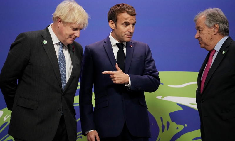British Prime Minister Boris Johnson (left) and UN Secretary-General Antonio Guterres (right) greet French President Emmanuel Macron as they arrive for day two of COP26 on November 1, 2021 in Glasgow, Scotland. The conference will run for two weeks, ending on November 12. Photo: VCG