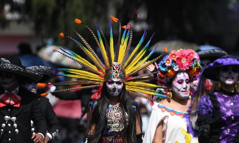 People in ghostly masks and costumes take part in the Day of the Dead Parade in downtown Mexico City, capital of Mexico, on Oct. 31, 2021.Photo:Xinhua