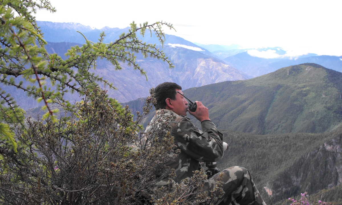 Zhong Tai, former deputy director at the management and protection bureau of Baima Snow Mountain National Nature Reserve in Yunnan, is communicating with collagues during a patrol in the wild. Photo: Courtesy of Baima Snow Mountain National Nature Reserve