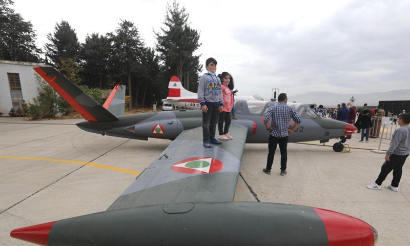 Children stand on a wing of a plane during an open day at Rayak Air Base in Bekaa, Lebanon, on Oct. 31, 2021.Photo:Xinhua