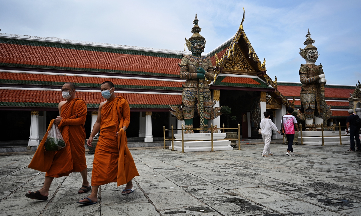  Buddhist monks walk inside the Grand Palace, a day after Thailand welcomed the first travelers vaccinated against COVID-19 to enter the country without the need for a two-week quarantine, in Bangkok on Tuesday.  Photo: AFP