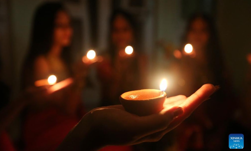 Indian women light oil lamps on the occasion of Diwali, the festival of Lights, in Bhopal, capital of India's Madhya Pradesh, Nov 3, 2021. The festival of Diwali falls on Nov 4.Photo:Xinhua