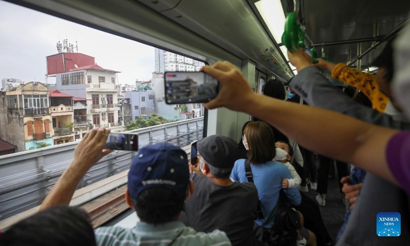 Passengers take photos on a train on Cat Linh-Ha Dong metro line in Hanoi, Vietnam, Nov. 6, 2021. Authorities of the Vietnamese capital Hanoi inaugurated the China-built Cat Linh-Ha Dong metro line project on Saturday, making it the first metro line in the country to start commercial operation. Photo: Xinhua