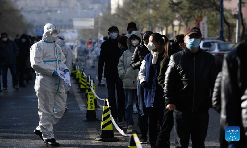 A staff member holds QR codes for citizens to register health information at a testing site in Chengxi District of Xining, northwest China's Qinghai Province, Nov. 8, 2021. Xining started its second round of mass nucleic acid testing at 9 a.m. on Monday. As of Nov. 7, Xining finished the first round of testing, and all swab samples from 1,448,000 citizens came back negative. (Xinhua/Zhang Long)