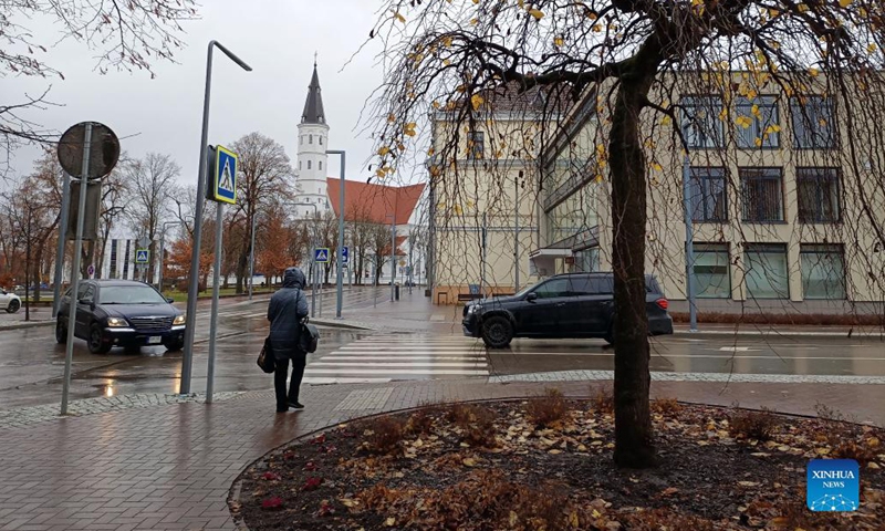 A citizen walks on the street in Siauliai, Lithuania, Nov. 6, 2021. The Lithuanian government has agreed to offer a one-off payment of 100 euros (116 U.S. dollars) to seniors aged 75 years and over who get fully vaccinated against COVID-19 by Dec.1 and those who take their booster shots by April 1, 2022. (Xinhua/Xue Dongmei)