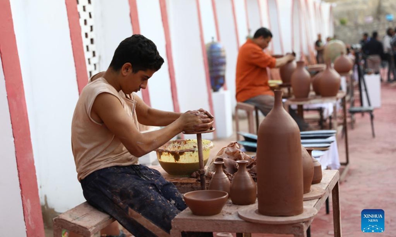 Pottery craftsmen show pottery making techniques during a pottery exhibition held at Fustat Pottery Village in Cairo, Egypt, Nov. 6, 2021. A two-day pottery exhibition opened on Saturday at the Fustat Pottery Village, with the aim of publicizing traditional Egyptian pottery cultures and reviving pottery industry.Photo: Xinhua