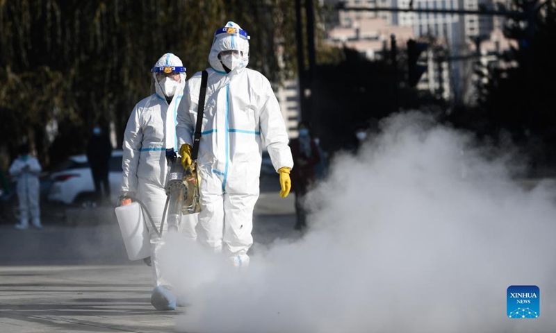 Staff members spray disinfectant at a testing site in Chengxi District of Xining, northwest China's Qinghai Province, Nov. 8, 2021. Xining started its second round of mass nucleic acid testing at 9 a.m. on Monday. As of Nov. 7, Xining finished the first round of testing, and all swab samples from 1,448,000 citizens came back negative. (Xinhua/Zhang Long)