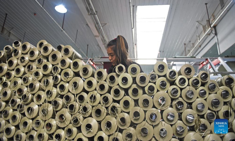A worker works at a packaging material industrial park at Yopurga County in Kashgar, northwest China's Xinjiang Uygur Autonomous Region, Nov. 8, 2021. The industrial park, mainly engaged in the production and sales of packaging materials such as woven bags, has attracted a total of 19 enterprises, providing 1,500 jobs for local residents.Photo: Xinhua