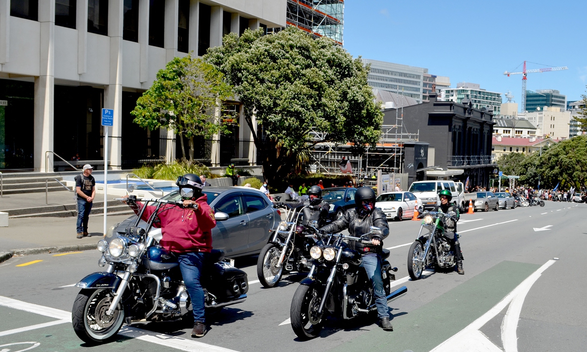 Bike riders gather for a Freedom and Rights Coalition demonstration to demand an end to COVID-19 restrictions and mandatory vaccination outside the Parliament House building in Wellington, New Zealand on Tuesday. Photo: AFP