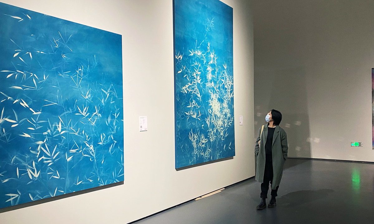 A visitor explores the paintings at the Chengdu Biennale in Chengdu, Sichuan Province. Photo: Courtesy of Xiao Min