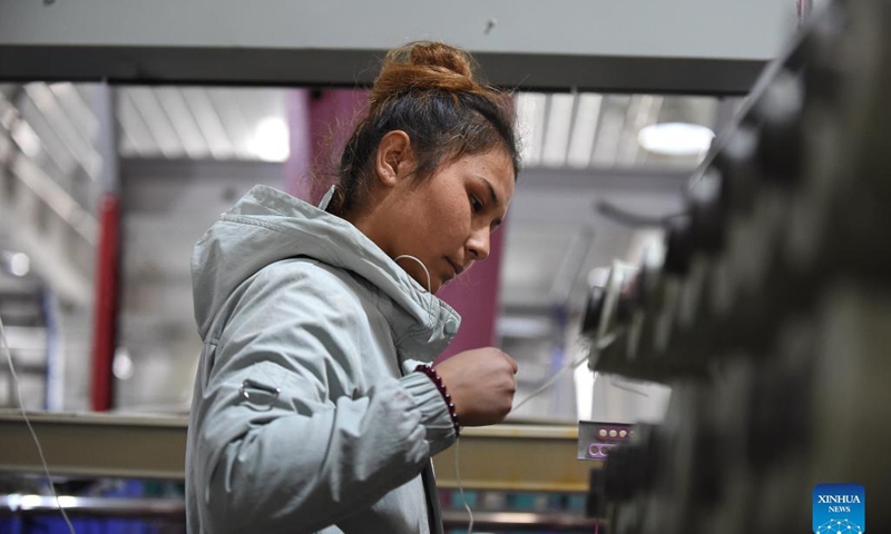 A worker works at a packaging material industrial park at Yopurga County in Kashgar, northwest China's Xinjiang Uygur Autonomous Region, Nov. 8, 2021. The industrial park, mainly engaged in the production and sales of packaging materials such as woven bags, has attracted a total of 19 enterprises, providing 1,500 jobs for local residents.Photo: Xinhua