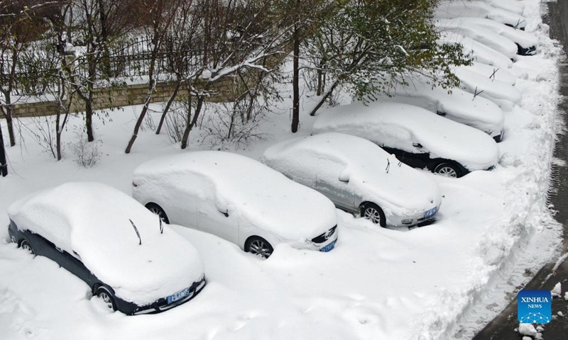 Aerial photo shows cars covered by snow at a park in Shenyang, northeast China's Liaoning Province, Nov. 9, 2021. A lingering blizzard since Sunday has brought record snowfall, the biggest since 1905, in Shenyang, the local meteorological authority said Tuesday. As of 8 a.m. Tuesday, the average snowfall in the city reached 51 mm. (Xinhua/Yang Qing)