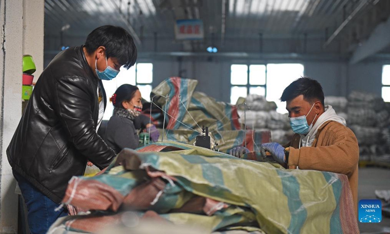 Workers work at a packaging material industrial park at Yopurga County in Kashgar, northwest China's Xinjiang Uygur Autonomous Region, Nov. 8, 2021. The industrial park, mainly engaged in the production and sales of packaging materials such as woven bags, has attracted a total of 19 enterprises, providing 1,500 jobs for local residents.Photo: Xinhua