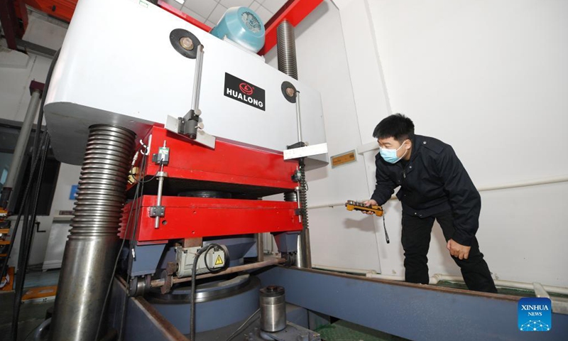 A staff member conducts examinations at a laboratory of CSCEC (China State Construction Engineering Corporation) Road and Bridge Group Co., Ltd. in Shijiazhuang, north China's Hebei Province, Nov. 8, 2021. The lab serves to examine the quality of raw materials of a series of infrastructure construction projects.Photo: Xinhua
