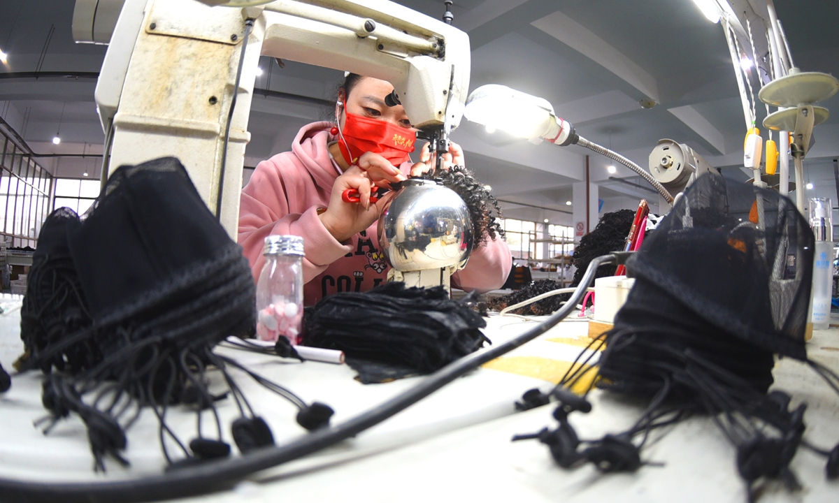 Workers produce wigs in Lianyungang, East China's Jiangsu Province on November 10, 2021. Chinese producers play an important role in global wig production, but the COVID-19 pandemic cut production, and transportation issues are hindering the collection of raw material. Photo: cnsphoto