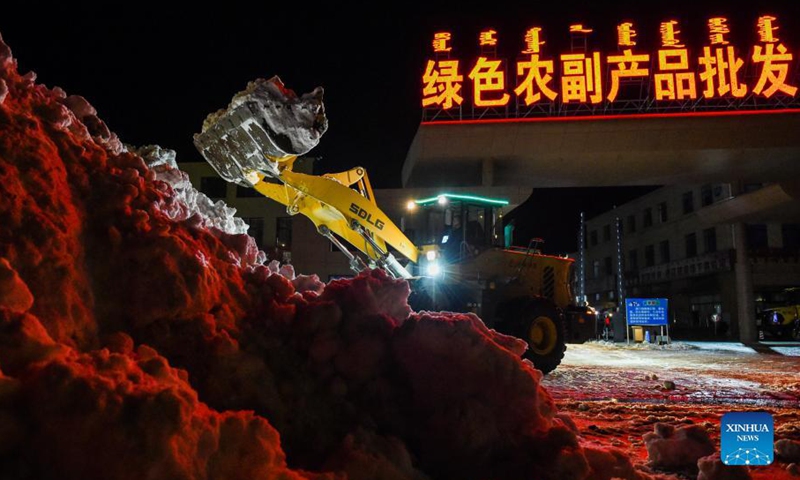 A vehicle shovels snow from the road in Tongliao, north China's Inner Mongolia Autonomous Region, Nov. 11, 2021. In response to the record blizzard, Tongliao government has carried out snow removing operations round-the-clock to resume local transportation.Photo:Xinhua