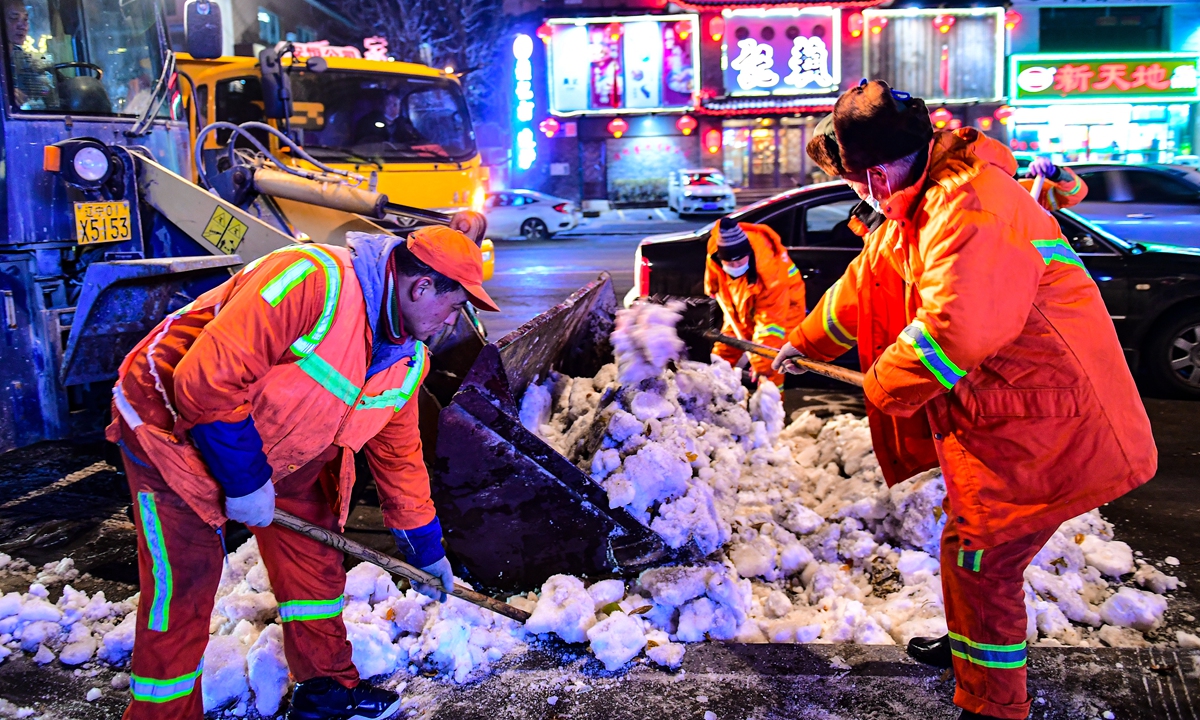 Sanitation workers clean snow on the road in Shenyang, Northeast China's Liaoning Province on November 12. Photo: VCG