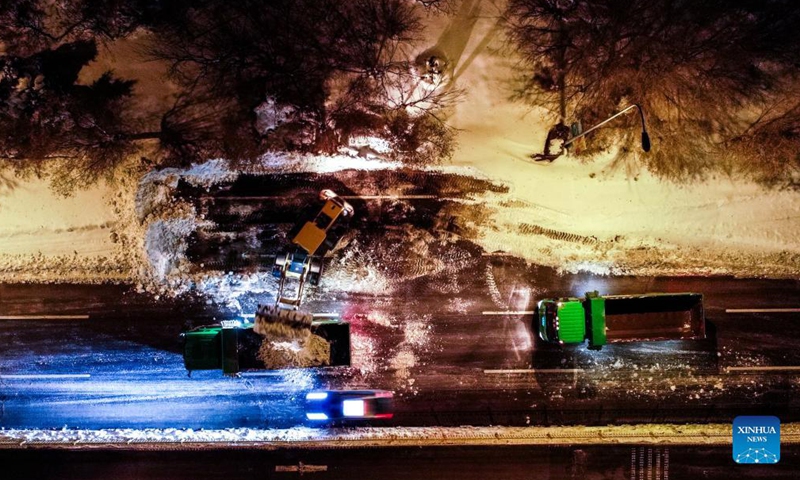 Aerial photo shows a vehicle shoveling snow from the road in Tongliao, north China's Inner Mongolia Autonomous Region, Nov. 11, 2021. In response to the record blizzard, Tongliao government has carried out snow removing operations round-the-clock to resume local transportation.Photo:Xinhua
