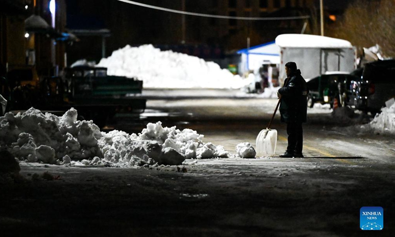 A staff member shovels snow in Tongliao, north China's Inner Mongolia Autonomous Region, Nov. 11, 2021. In response to the record blizzard, Tongliao government has carried out snow removing operations round-the-clock to resume local transportation. Photo:Xinhua