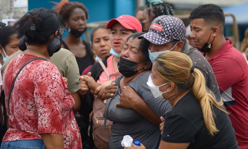 People wait outside the Litoral Penitentiary to receive information about their relatives after clashes occurred in the prison in Guayaquil, Ecuador, Nov. 13, 2021.Photo:Xinhua
