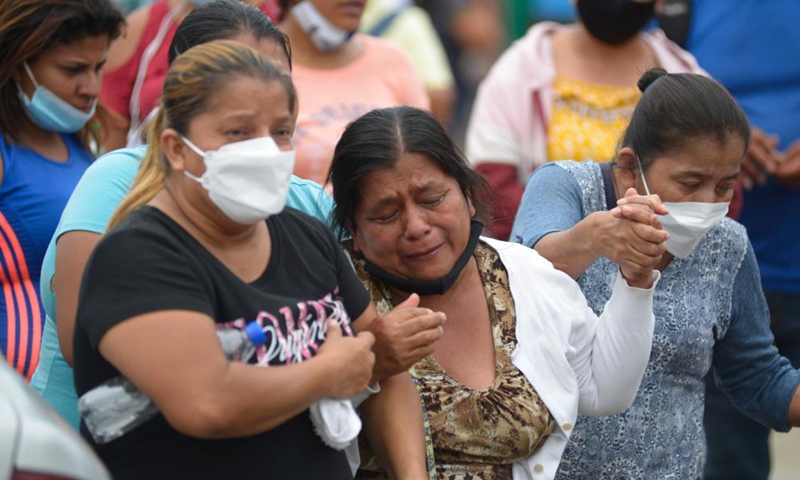 People wait outside the Litoral Penitentiary to receive information about their relatives after clashes occurred in the prison in Guayaquil, Ecuador, Nov. 13, 2021.Photo:Xinhua