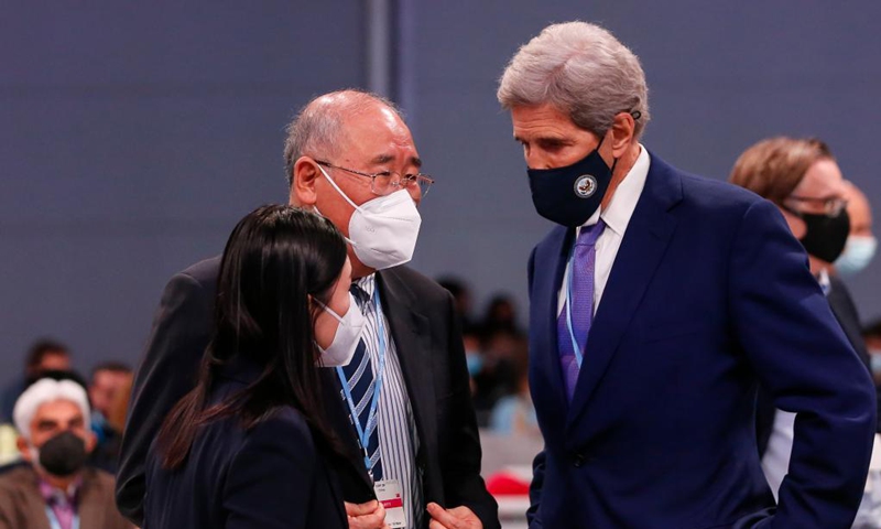 Xie Zhenhua (C), China's special envoy for climate change, speaks with John Kerry (R), U.S. special presidential envoy for climate, during the 26th session of the Conference of the Parties (COP26) to the United Nations Framework Convention on Climate Change in Glasgow, the United Kingdom, Nov. 13, 2021.Photo: Xinhua 