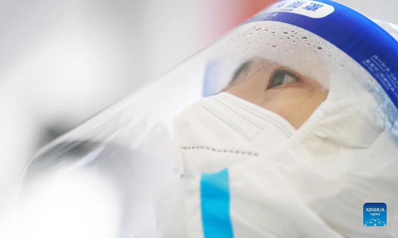 A medical worker takes a swab sample from a resident at a nucleic acid testing site in Xiangfang District of Harbin, northeast China's Heilongjiang Province, Nov. 15, 2021. Photo: Xinhua