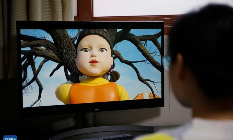 A person watches the South Korean drama Squid Game at home in Seoul, South Korea, Nov. 15, 2021. The South Korean drama Squid Game has drawn worldwide attention as it vividly depicts the cruelty of capitalistic society through children's games played by a group of debt-ridden underdogs for money. Photo: Xinhua