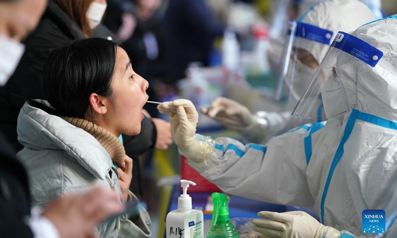 Medical workers take swab samples from citizens at a nucleic acid testing site in Xiangfang District of Harbin, northeast China's Heilongjiang Province, Nov. 15, 2021. Photo: Xinhua