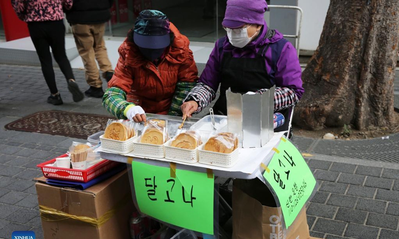 Street vendors sell dalgona candies in Myeongdong shopping street in Seoul, South Korea, Nov. 13, 2021. Dalgona is a significant element of South Korean drama Squid Game, with a deadly version of the dalgona challenge being the second game played in the series. Photo: Xinhua