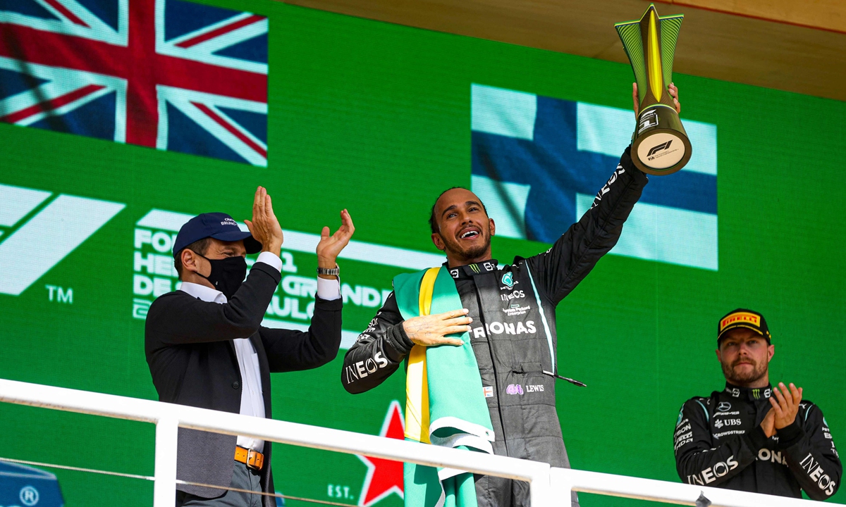 Lewis Hamilton holds the trophy on the podium on Sunday in Sao Paulo, Brazil. Photo: VCG