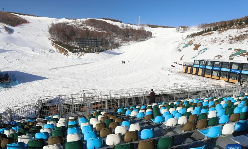 A staff member patrols at the seats of Yunding Ski Resort in Chongli of Zhangjiakou City, north China's Hebei Province, Nov. 16, 2021. The seats of Yunding Ski Resort in Zhangjiakou competition zone have been installed, and the staff are busy preparing the tracks for the upcoming test events of the Beijing 2022 Olympic Winter Games. Photo: Xinhua