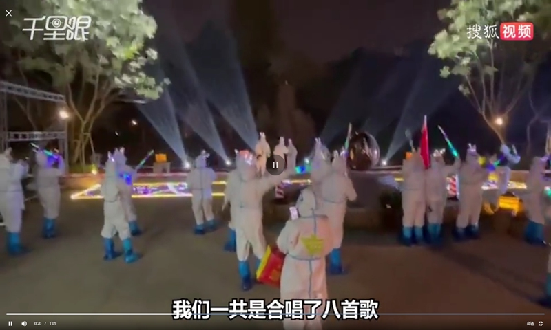 Medical workers in white protective suits waved colorful glow sticks and wore rabbit ear ornaments as the area under COVID-19 lockdown held open-air dance party. Photo: screenshot on Sina Weibo. 