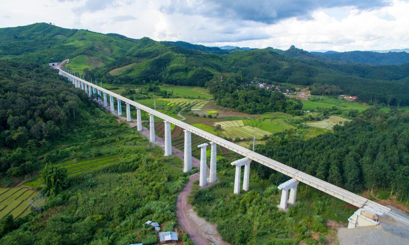 Aerial photo taken on July 29, 2020 shows the China-Laos railway over the villages and fields in northern Laos. The world was a very different place five years ago when work began on the China-Laos railway. Much has changed since then, in almost every walk of life. But five years on, with completion of the railroad just weeks away, the natural environment along the route remains as verdant and lush as it was before the earthmovers arrived. Photo: Xinhua 