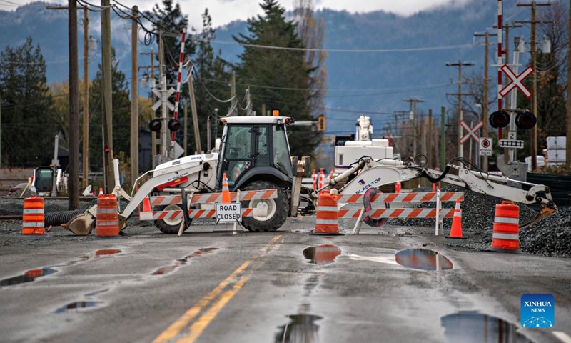 A road is closed due to floods caused by rainstorms in Abbotsford, Canada, Nov. 18, 2021. Incessant rainfall in the British Columbia brought floods to Abbotsford and the Fraser Valley that resulted in the provincial premier declaring a state of emergency. (Photo by Andrew Soong/Xinhua)