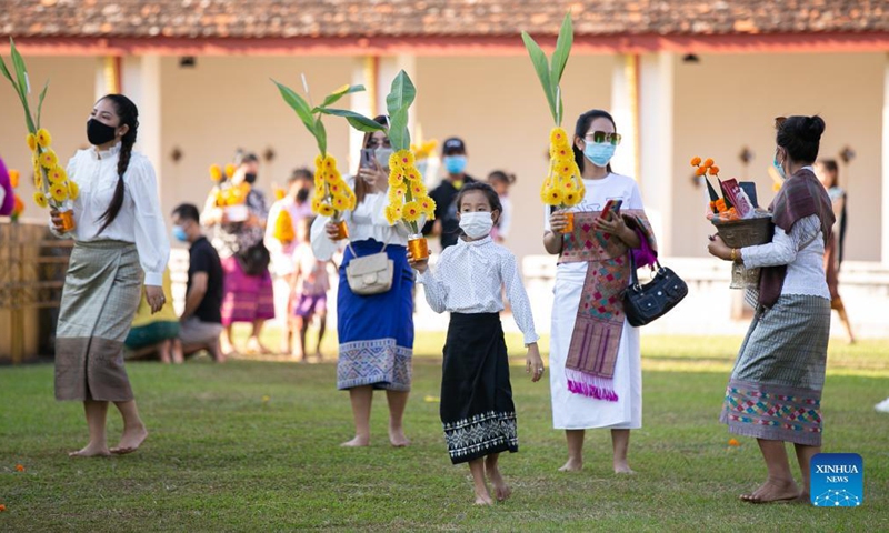 People pray around the That Luang Stupa in Vientiane, Laos, Nov. 18, 2021. The That Luang Festival, the most important religious festival in Laos, was observed by Lao people from all over the country around the That Luang Stupa. (Photo by Kaikeo Saiyasane/Xinhua)