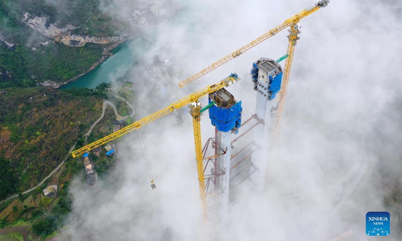 Aerial photo taken on Nov. 21, 2021 shows the main tower of Tongzi River grand bridge in southwest China's Guizhou Province. The main tower of the Tongzi River grand bridge was capped on Sunday. The 1,422-meter-long bridge is an important part of the Jinsha-Renhuai-Tongzi Highway. (Xinhua)