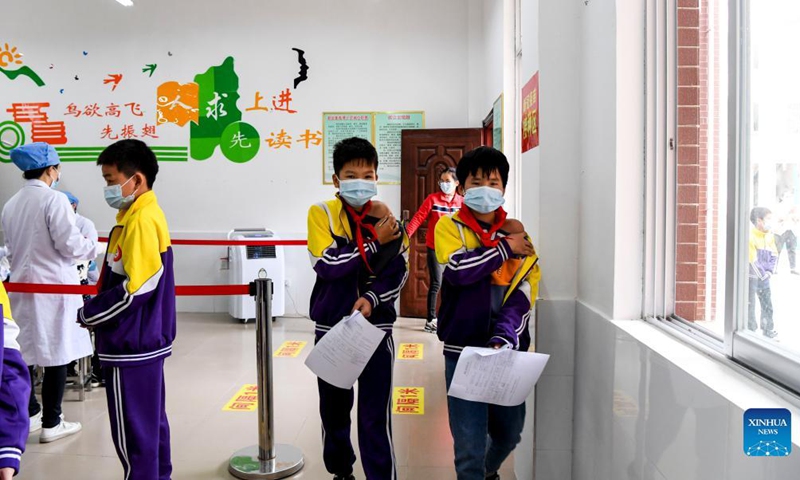 Pupils walk to the observation area after getting inoculated with the COVID-19 vaccines at Weiming elementary school in Weiming Village, Shinan Township, Xingye County, south China's Guangxi Zhuang Autonomous Region, Nov. 18, 2021. Photo: Xinhua