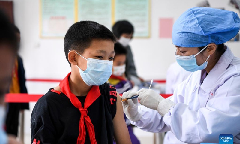 Pupils get inoculated with the COVID-19 vaccines at Weiming elementary school in Weiming Village, Shinan Township, Xingye County, south China's Guangxi Zhuang Autonomous Region, Nov. 18, 2021. Photo: Xinhua