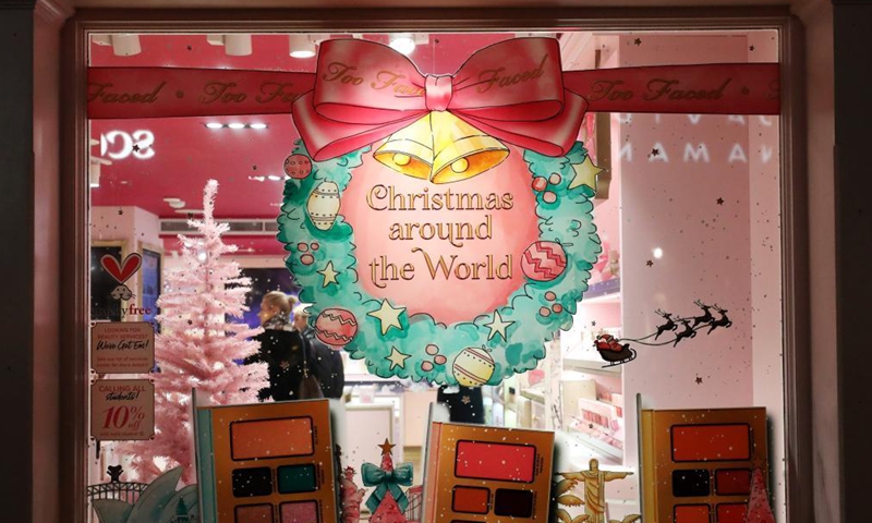 People shop in a store, which is decorated for Christmas, in central London, Britain, on Nov. 21, 2021.(Xinhua)