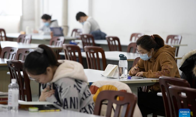 People read at the provincial library in Harbin, northeast China's Heilongjiang Province, Nov. 18, 2021. Harbin terminated its emergency responses to COVID-19 on Thursday and started advancing the full restoration of the normal economic and social order after the recent resurgence of COVID-19 has been subdued. Photo: Xinhua
