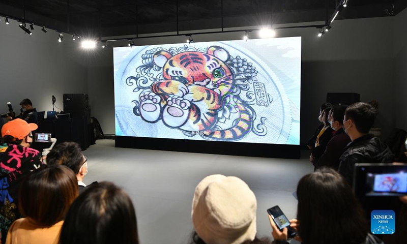 Participants watch a trailer promoting the commemorative coins to celebrate the Chinese zodiac Year of the Tiger at a ceremony in Beijing, capital of China, Nov. 18, 2021. China's central bank issued a set of gold and silver commemorative coins on Thursday to celebrate the Chinese zodiac Year of the Tiger. Photo: Xinhua